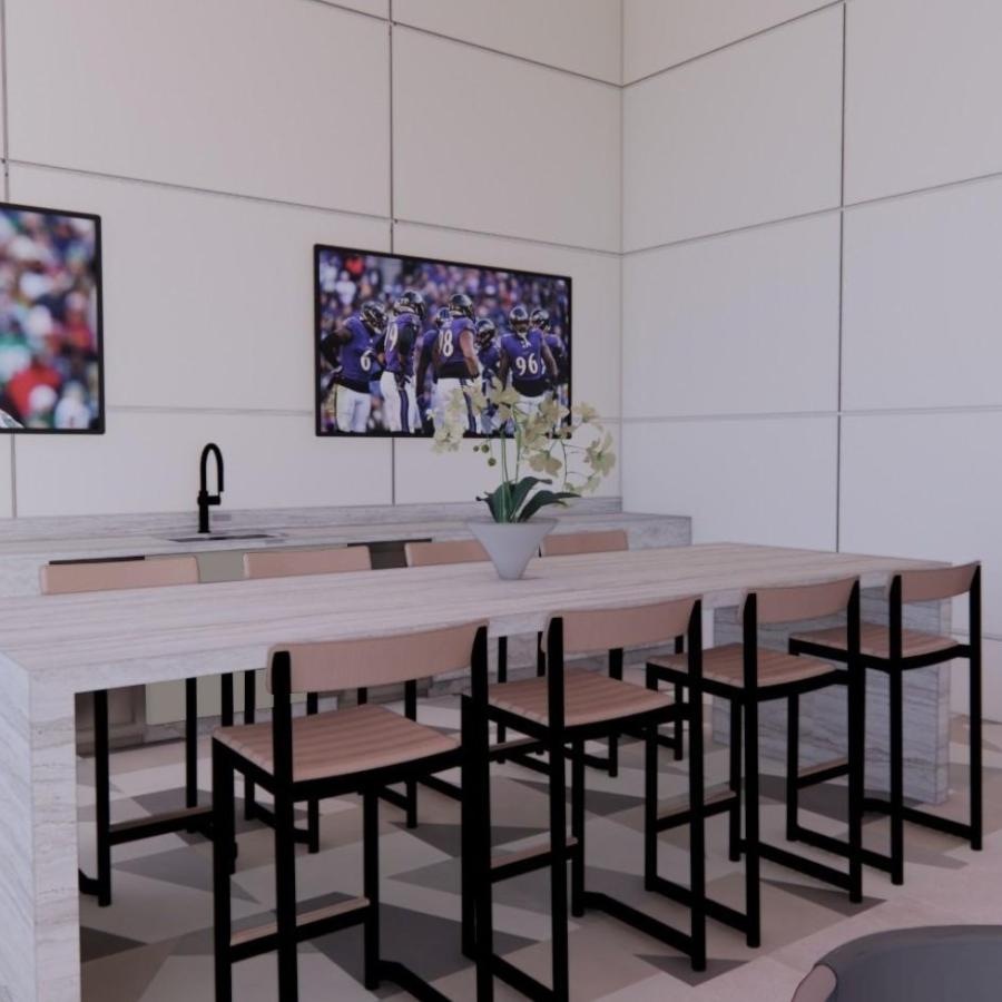 a clubroom with tv's, a table and chairs